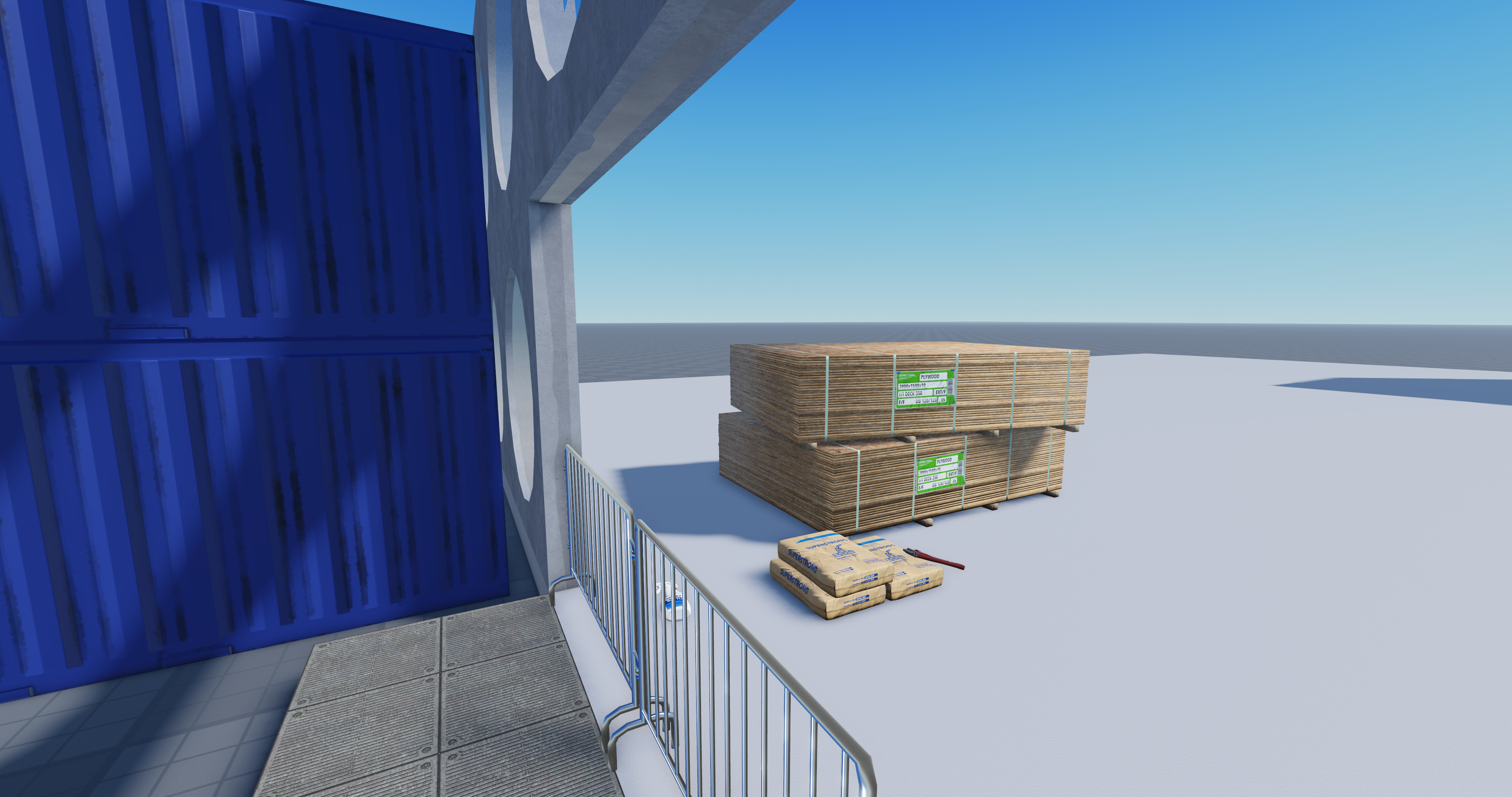 Another consturction site with piles of plywood and concrete sacks. In the foreground is a unfinished wall
